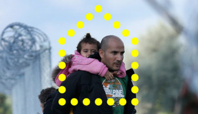 Un refugiado con una niña pequeña en brazos